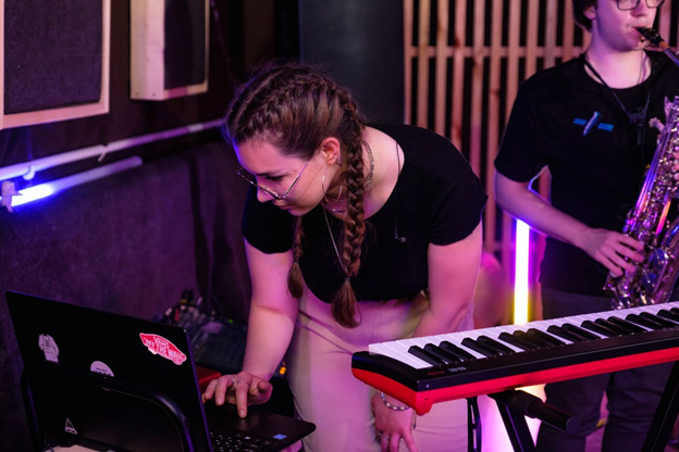 a person using musical instruments at a recording studio