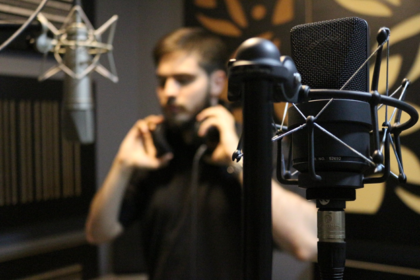 a person recording a voice-over at a recording studio